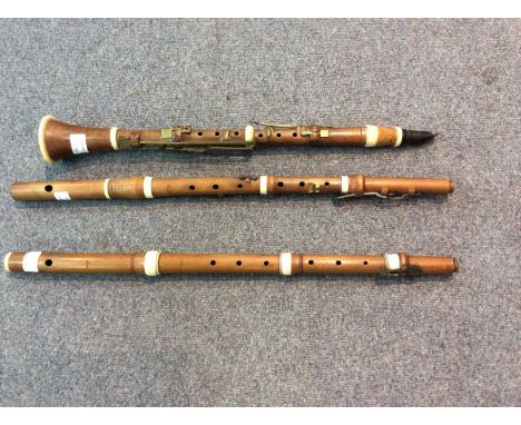 A boxwood clarinet stamped Whitaker, London and two boxwood flutes, one by Peltier the other by Potter, Johnson's Court, Flee