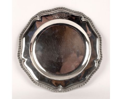 A George II silver plate, George Wickes, London 1758, of wavy outline with gadrooned rim, bears armorial, 24.5cm wide, approx