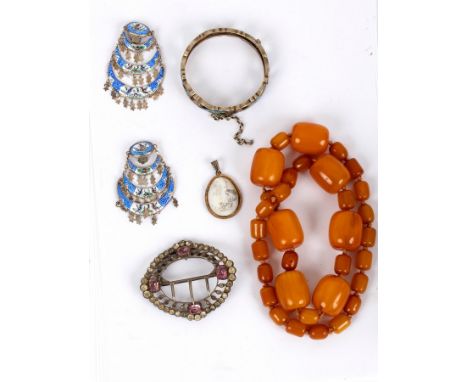 A Chinese silver bangle with enamelled decoration, a small Chinese pendant, a pair of enamel ear clips, a paste set buckle an
