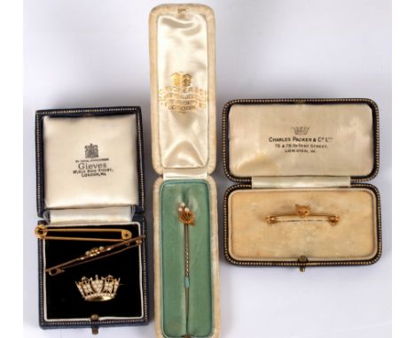 An Edwardian fox mask stock pin, set in 15ct gold, one ruby eye missing, boxed by C Packer, Regent St., a pearl set naval cro