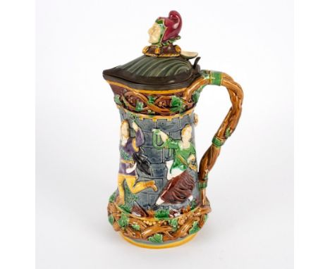 A Minton majolica tower jug, circa 1880, impressed marks, with a pewter mounted hinged cover, modelled with a jester's head f