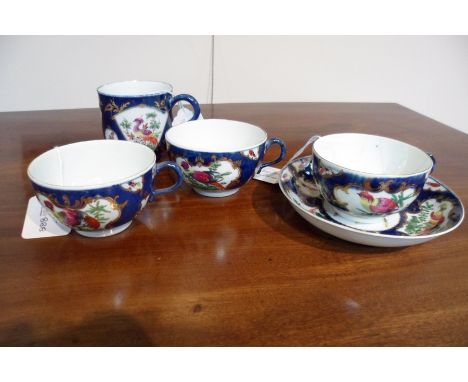 Three Worcester blue scale ground teacups and a saucer, circa 1770, painted birds and insects in mirror cartouches and a larg