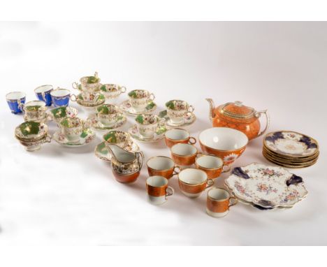 A group of English teawares, circa 1810-1840, to include an orange ground teapot and cover and a part set of green ground tea