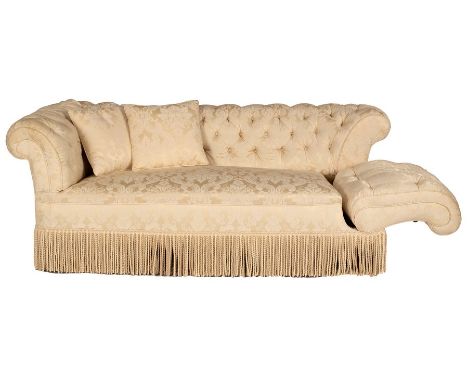 A button back Chesterfield sofa upholstered in cream damask with a fringed border on square tapering front legs, one lever op