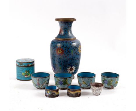 A cloisonné vase of baluster shape, decorated flowers to a blue ground, 26cm high, four cloisonné enamel tea bowls, a cloison