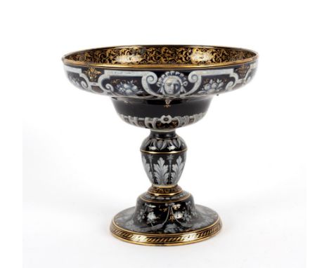 A Minton Limoges enamel style black ground coupe, circa 1855-60, gilt Minton mark, decorated in white enamel with masks and s