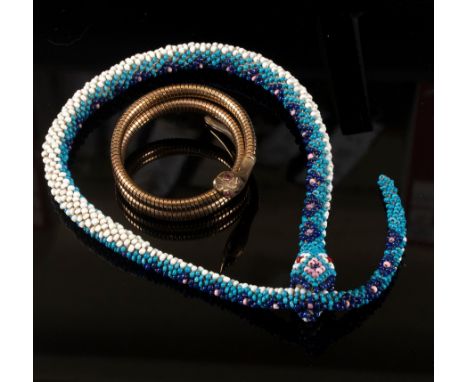 A yellow gold serpent bracelet, S & P, Chester 1959, with ruby eyes, approximately 29.7gm and a Turkish beadwork snake CONDIT