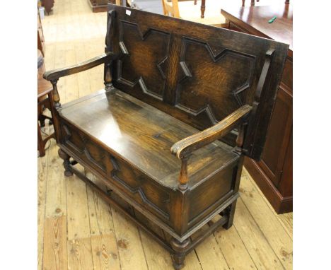 A 1920's carved oak monk's bench 