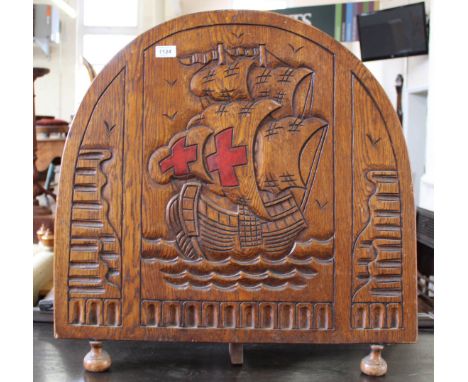 A heavy Arts and Crafts oak fire screen carved with a galleon on choppy waters 