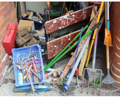 A selection of wood working and gardening tools and a workmate