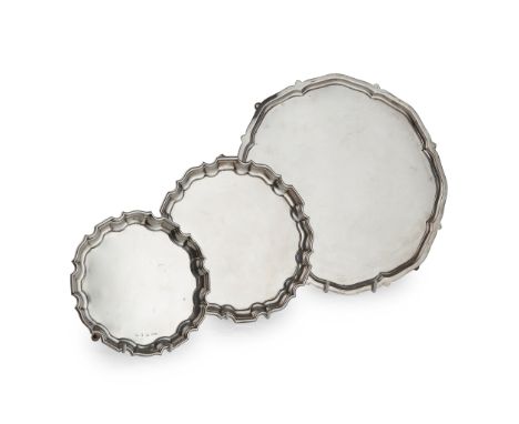 A group of three salvers and trays Harrison Brothers &amp; Howson, Sheffield 1935, of shaped circular form, on three bracket 