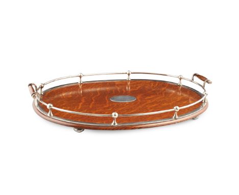 RAILWAY INTEREST - A late Victorian presentation silver-mounted oak tray Hammond, Creake &amp; Co, Sheffield 1893, of oval ou