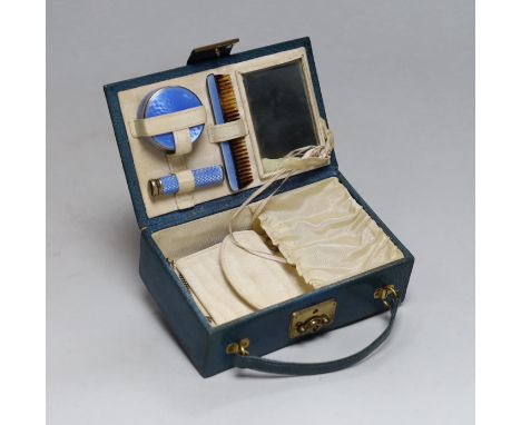 A lady's 1920's small leather vanity case, containing an enamelled comb, pill box and lipstick holder, the latter two with si