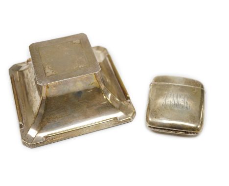 A 1930's Art Deco part engine turned silver mounted inkwell, 10.2cm and a large silver vesta case.