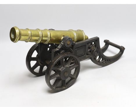 A cast iron and brass model cannon, 47cm long
