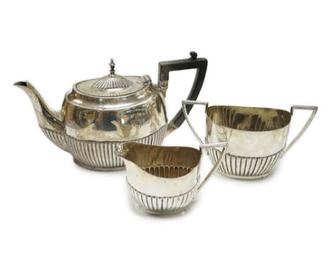 A matched early 20th century silver bachelor's three piece tea set, tea pot, James Dixon &amp; Sons, Sheffield, 1920, cream a