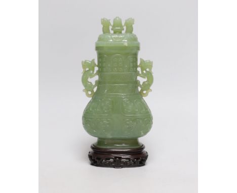 A Chinese carved bowenite jade vase and cover on hardwood stand, 23cm, with fitted case