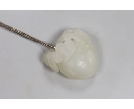 A Chinese white jade "bat and peach" pendant