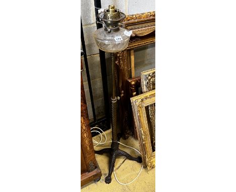 A late Victorian adjusting brass oil lamp standard (converted) on associated telescopic cast iron stand, height 112cm