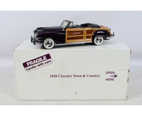 Danbury Mint -  A boxed 1/24 scale 1948 Chrysler Town & Country. Item appears in excellent-near mint condition. Housed in ori
