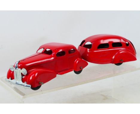Wyandotte - An unboxed tinplate car with caravan in red. Item appears in excellent condition; a slight scuff at the front of 