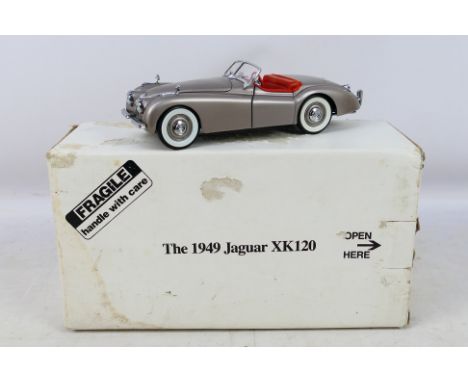 Danbury Mint -  A boxed 1/24 scale 1949 Jaguar XK120. Item appears in excellent condition. Housed in original polystyrene inn