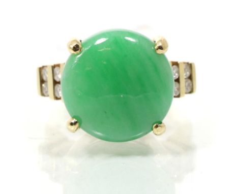 A jade and diamond ring, a round cabochon jade to diamond set shoulders, total estimated diamond weight 0.20 carat approximat