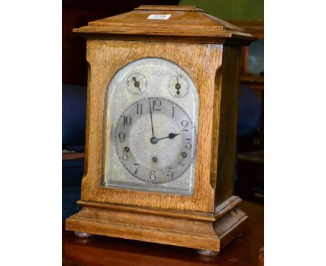 An oak bracket clock with silvered Arabic dial 