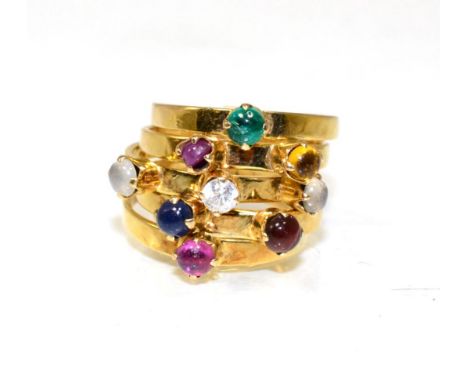 A multi-gemstone stacking ring, of five bands each set with a cabochon, including emerald, citrine, paste, moonstone, ruby an