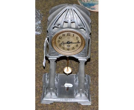 An Art Nouveau pewter portico clock, the stylised top raised on four pilars, the dial signed Junghans