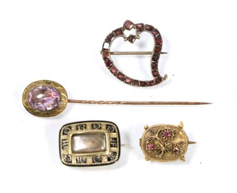 A flat cut garnet witches heart brooch, measures 2.5cm by 2.2cm; a Victorian black enamel and hairwork mourning brooch, an am