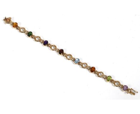 A 9 carat gold gem set bracelet, oval cut citrine, amethyst, garnet, topaz and peridot spaced by fancy links, length 17.5cm, 