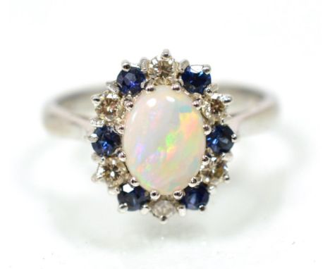 An opal, sapphire and diamond cluster ring, an oval cabochon opal within a border of round brilliant cut diamonds and round c