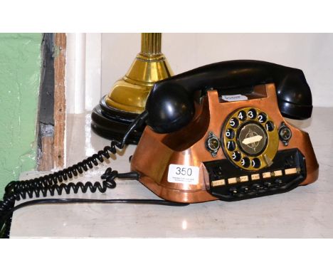 A copper and bakelite rotary telephone 