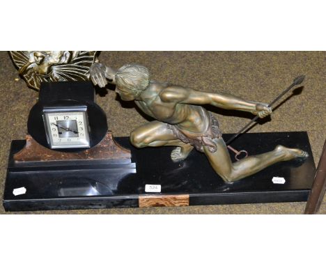 A large Art Deco figural mantel clock, mounted with a patinated figure of a hunter with a spear