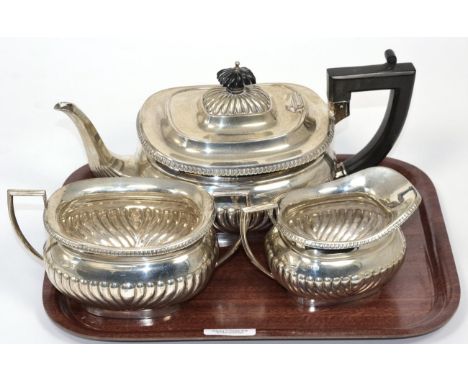 A silver three piece tea service, Alexander Clark, Birmingham 1935, part fluted with egg and dart border, the teapot 29cm lon