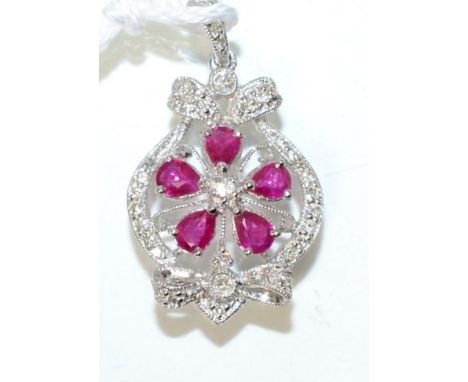 A ruby and diamond pendant, five pear cut rubies within a grain set diamond frame, stated total diamond weight 0.20 carat, me