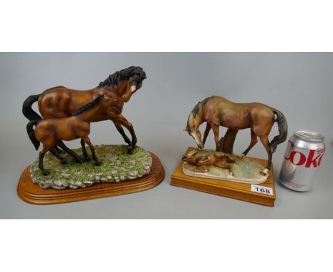 2 ceramic horse figures on wooden bases