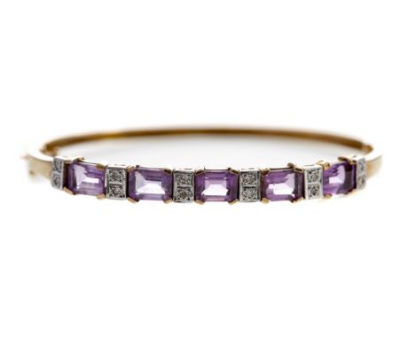 PURPLE GEM SET AND DIAMOND BANGLE, the step cut purple gems interspaced by pairs of diamonds totalling approximately 0.24 car
