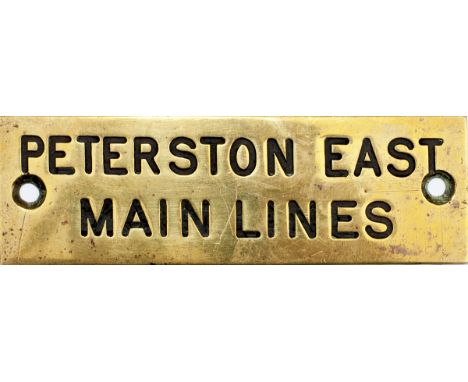 GWR brass shelf plate PETERSTON EAST MAIN LINES, machine engraved. Measures 4.75in x 1.5in.