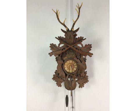 BLACK FOREST CUCKOO WALL CLOCK,with three train eight day movement striking on a coil at the half hour and playing one of two
