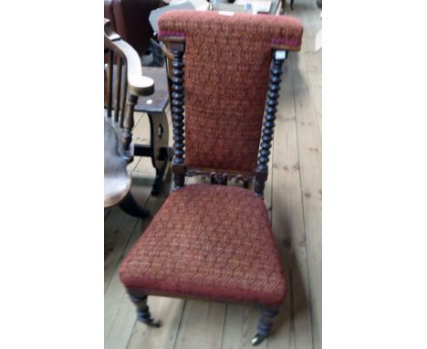 A Victorian mahogany framed child's Prie Dieu chair with tapestry upholstery and flanking bobbin turned uprights, set on turn