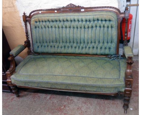 A 5' Victorian walnut show frame settee with original button back tapestry upholstery, decorative top rail and flanking acant