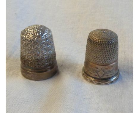 A silver thimble and another