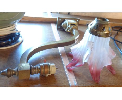 An Edwardian brass wall bracket light with frosted and cranberry shade
