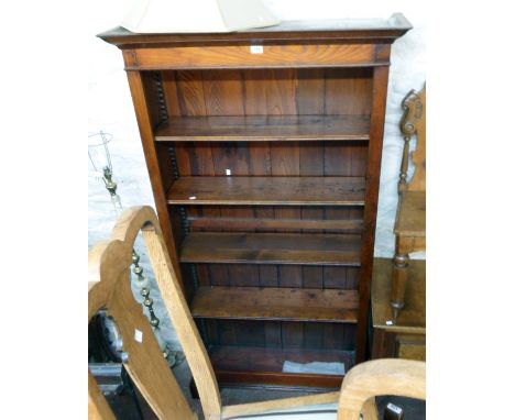 A 3' 4" antique style stained oak four shelf open bookcase with moulded top, adjustable shelves and bracket feet