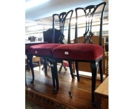 A pair of early 20th Century mahogany framed Chippendale style standard chairs with upholstered seats, set on slender cabriol