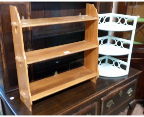 A 22" stained wood wall mounted three shelf unit with pegged standard ends - sold with a small painted canework three shelf c