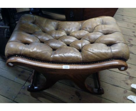 A 20th Century mahogany X-frame stool with studded button back leather upholstery, set on scroll supports and turned stretche