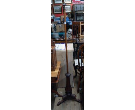 A 19th Century mahogany pole screen standard with finial to top and ornate tripod base with carved hoof pattern feet